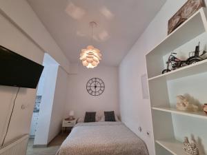 a bedroom with a bed and a chandelier at Apartments Lav in Umag