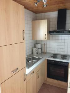 a small kitchen with a sink and a stove at Haus Serena in Sonnenalpe Nassfeld