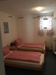 Zimmer mit 3 Betten und einem Fenster in der Unterkunft Haus Serena in Sonnenalpe Nassfeld