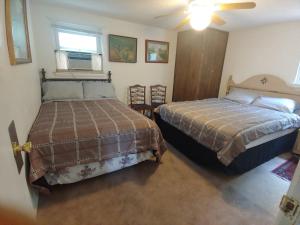 a bedroom with two beds and a window at VA Beach Zen retreat house in Virginia Beach