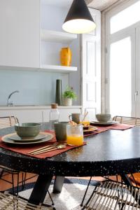 a kitchen with a black table with food on it at Impar luxury residence in Porto