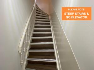 a staircase with a sign that reads sleep stairs and no elevator at Xplore Hostel Amsterdam in Amsterdam