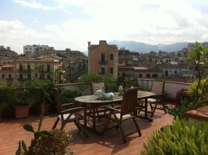 a patio with a table and chairs on a balcony at Alle Terrazze del Borgo Vecchio in Palermo