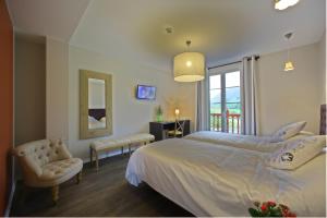 Letto o letti in una camera di Hotel Agian - Maison Bonnet
