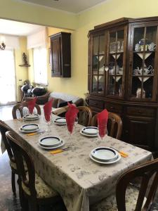 a dining room table with plates and glasses on it at VILLA FELICE in Loano