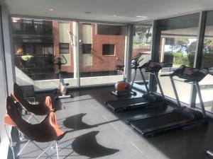 a gym with treadmills and exercise equipment in a room at Incomparable Vista al Golf in Mar del Plata