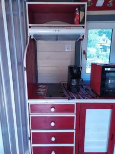 a kitchen in an rv with a stove in it at La Roulotte de Francine in Chazeuil +23 photos