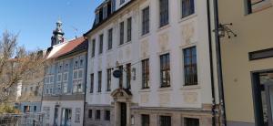 a large white building on a city street at Altstadt Palais in Weimar