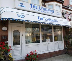 a store with a sign on the front of a building at Lyndawn hotel in Blackpool