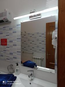 a mirror over a sink in a bathroom at Casa Rural Las Mestas in Cangas del Narcea +54 photos