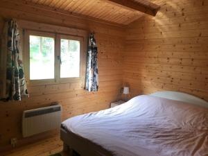 a bedroom with a bed in a log cabin at Beautiful 3-Bed Cottage in Tipperary in Tipperary
