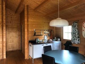 a kitchen and dining room with a table in a cabin at Beautiful 3-Bed Cottage in Tipperary in Tipperary