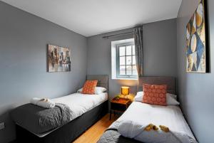 a bedroom with two beds and a window at The Maelor - Berwyn House in Wrexham