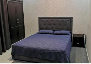 een slaapkamer met een paars bed met een zwart hoofdeinde bij Superbe appartement F3 tout confort in Agadir