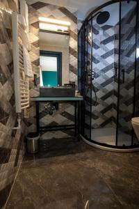 a bathroom with a sink and a mirror at Boutique Hotel Bura 45N in Senj +37 photos