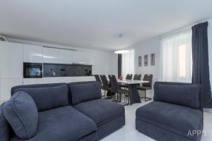 a living room with a couch and a table at Premium Tartini Apartment by Locap Group in Piran