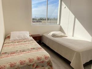 Tempat tidur dalam kamar di La Serena Costa