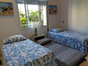 Кровать или кровати в номере Apê Descolado no Guarujá - Enseada