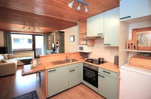 a kitchen with a sink and a stove top oven at Edelweiss Apartment in Maishofen
