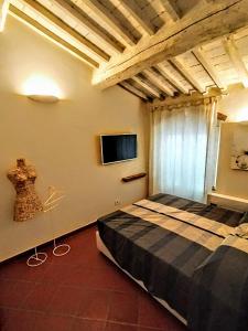 a bedroom with a bed and a flat screen tv at Castelfalfi Art Apartment in Castelfalfi