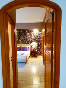 a hallway leading to a bedroom with a bed at Kouro's private room! in Piraeus