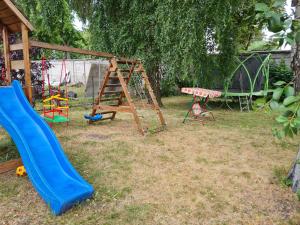 a playground with a slide and a swing at The Bunker hostel in Liepāja