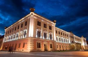 a large building is lit up at night at hortenzia in Alba Iulia