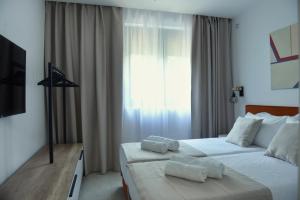 a hotel room with two beds and a window at 9 apartments in Jagodina
