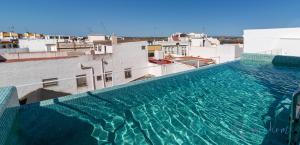 a swimming pool on the roof of a building at LUXURY APARTAMENTOS Doña Bella in Ayamonte