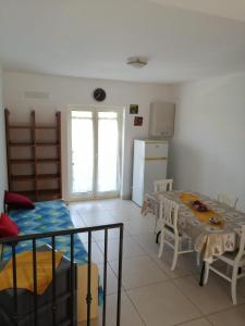 a living room with a table and a kitchen at Brigida's Apartments in Ipsos +45 photos