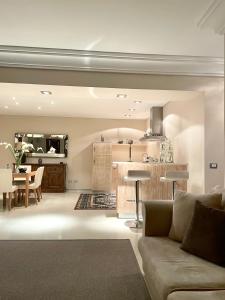 a living room with a couch and a kitchen at Double A Luxury Apartment in Olbia