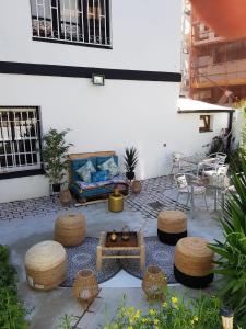 a patio with a couch and a table and chairs at Villa nueva 1910 in Getxo