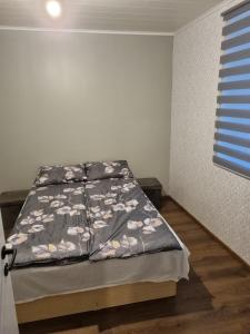 a bedroom with a bed with a blanket on it at Soelaane 12 Apartment2 in MikitamÃ¤e