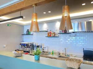a kitchen with two lights hanging over a sink at Tinos View Apartments in Tinos Town
