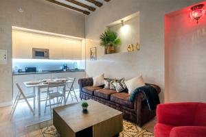 a living room with a couch and a table at Gadir Suites in Cádiz