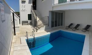 a swimming pool on the side of a house at Villa OpuZEN in Opuzen