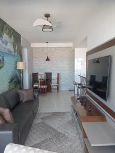 a living room with a couch and a dining room at Lazer nas Alturas in Vila Velha