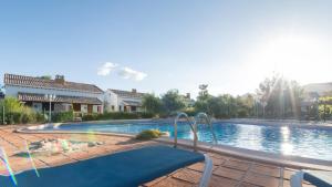 a large swimming pool in a yard with a house at Complejo Rural Ibipozo in Pozo Alcón