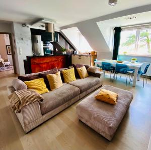 a living room with a couch and a table at Lake View Ostróda Luxury Apartment in Ostróda