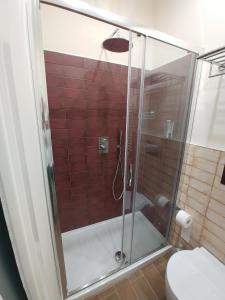 a glass shower in a bathroom with a toilet at San Domenico Casa Vacanze in Modica