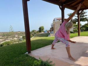 a little girl doing a handstand on a porch at Panorama Studios in Kefalos