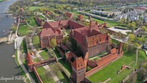 an aerial view of an old building on a field at MALTINA in Malbork