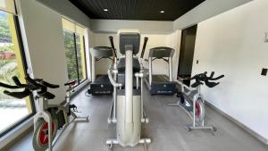 een fitnessruimte met loopbanden en crosstrainers bij Beverly Hills: Hotel and Business in San Salvador