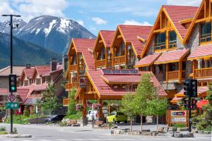 a large building with a lot of windows and lots of trees at Moose Hotel and Suites in Banff