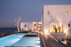 a villa with a swimming pool at night at Lyo Boutique Hotel Mykonos in Super Paradise Beach