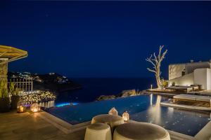 a villa with a swimming pool at night at Amyth of Mykonos Super Paradise in Super Paradise Beach