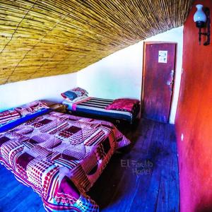 a bedroom with a bed and a window at El Farolito Hostel in Tilcara