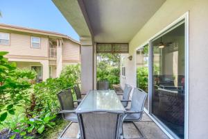 a patio with a glass table and chairs at Waikoloa Colony Villas 2202 in Waikoloa