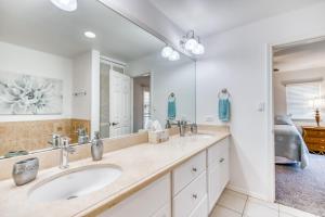 a bathroom with two sinks and a large mirror at Waikoloa Colony Villas 2202 in Waikoloa