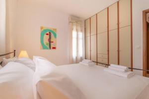 um quarto com 2 camas e lençóis brancos em Seaview Stylish Flat in Andros - walk to beach em Andros